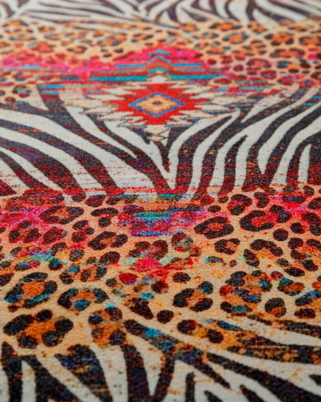 Makroaufnahme des auffälligen Animal-Print-Musters mit Zebra-, Leoparden- und Ethno-Elementen.