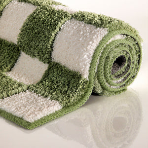 {"class" => "product-thumbnails__image", "alt" => "Badteppich von BathKing by WECONhome Bobbi Grün aufgerollt auf hellem Hintergrund, Seitenansicht zeigt Florhöhe und Musterverlauf"}