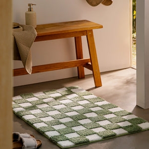{"class" => "product-thumbnails__image", "alt" => "Badteppich von BathKing by WECONhome Bobbi Grün im Badezimmer neben Holzbank auf hellem Boden liegend, rechteckige Matte mit Karomuster"}