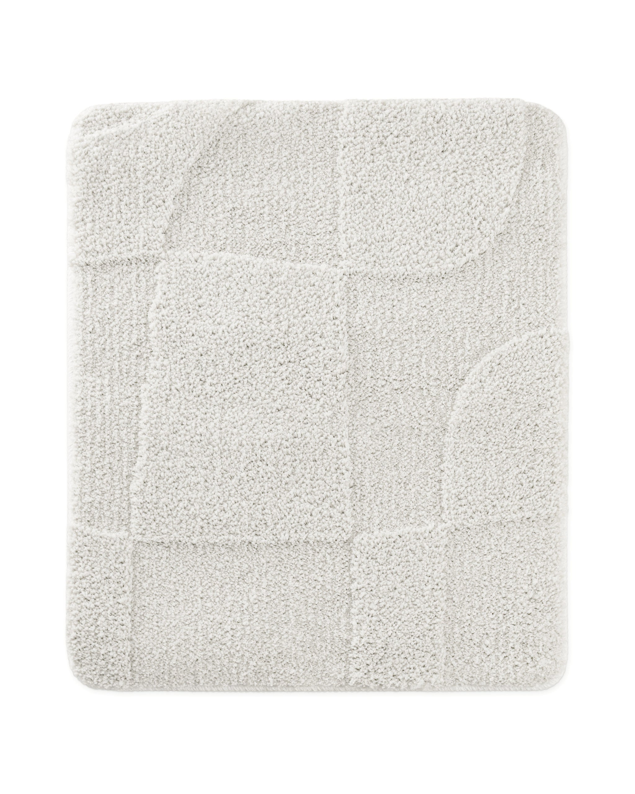 Badteppich von BathKing by WECONhome Davie Weiß rechteckig 55x65 cm, Draufsicht auf Matte mit eingeprägtem Linienmuster auf hellem Hintergrund