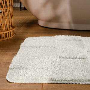{"class" => "product-thumbnails__image", "alt" => "Badteppich von BathKing by WECONhome Davie Weiß runde Matte im Badezimmer vor Badewanne, Strukturmuster im Flor auf Holzboden sichtbar"}