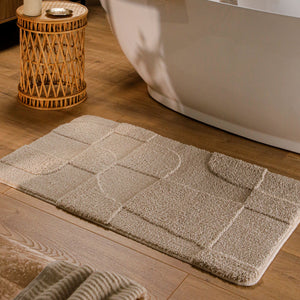 {"class" => "product-thumbnails__image", "alt" => "Badteppich von BathKing by WECONhome Davie Sand Beige rechteckig im Badezimmer vor Badewanne auf Holzboden liegend, Strukturmuster im Flor sichtbar"}