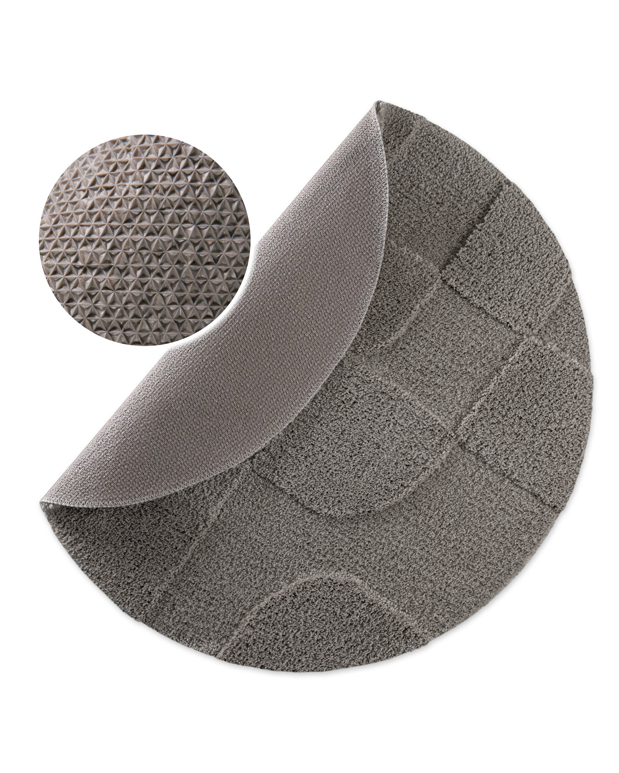 Badteppich von BathKing by WECONhome Davie Basalt Grau rund, angehobene Ecke zeigt Basalt Graue Rückseite mit rutschhemmender Beschichtung