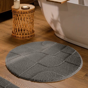 {"class" => "product-thumbnails__image", "alt" => "Runder Badteppich von BathKing by WECONhome Davie Basalt Grau im Badezimmer vor Badewanne auf Holzboden, strukturiertes Linienrelief im Flor sichtbar"}
