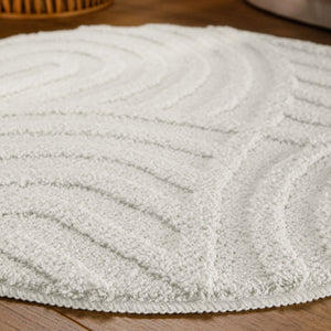 {"class" => "product-thumbnails__image", "alt" => "Badteppich von BathKing by WECONhome Fiete Weiß rund im Badezimmer auf Holzboden neben Badewanne, Florstruktur und Linienrelief erkennbar"}