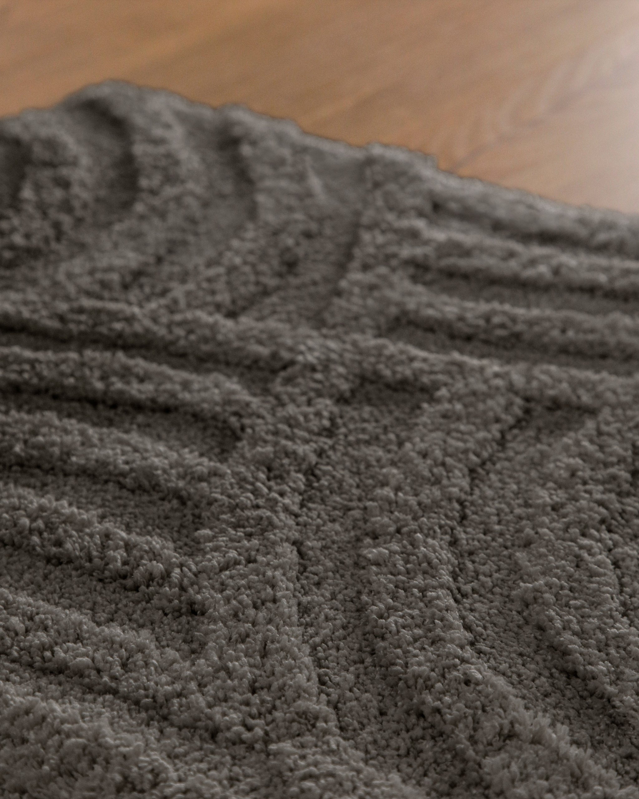 Badteppich von BathKing by WECONhome Fiete Basalt Grau Nahaufnahme der Florstruktur, Linienrelief im dichten Teppichflor sichtbar