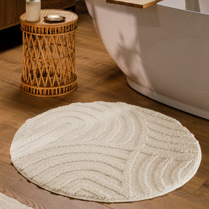 {"class" => "product-thumbnails__image", "alt" => "Runder Badteppich von BathKing by WECONhome Fiete Creme Weiß im Badezimmer vor Badewanne auf Holzboden, strukturiertes Linienrelief im Flor sichtbar"}