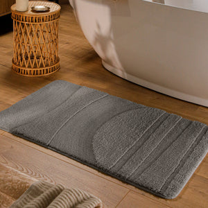{"class" => "product-thumbnails__image", "alt" => "Badteppich von BathKing by WECONhome Marc Basalt Grau rechteckig im Badezimmer vor Badewanne auf Holzboden liegend, Strukturmuster im Flor sichtbar"}