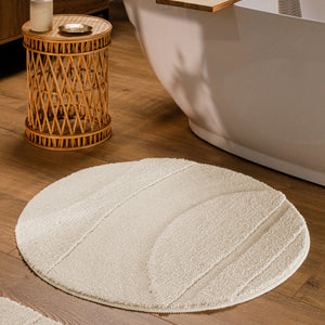 {"class" => "product-thumbnails__image", "alt" => "Runder Badteppich von BathKing by WECONhome Marc Creme Weiß im Badezimmer vor Badewanne auf Holzboden, strukturiertes Linienrelief im Flor sichtbar"}
