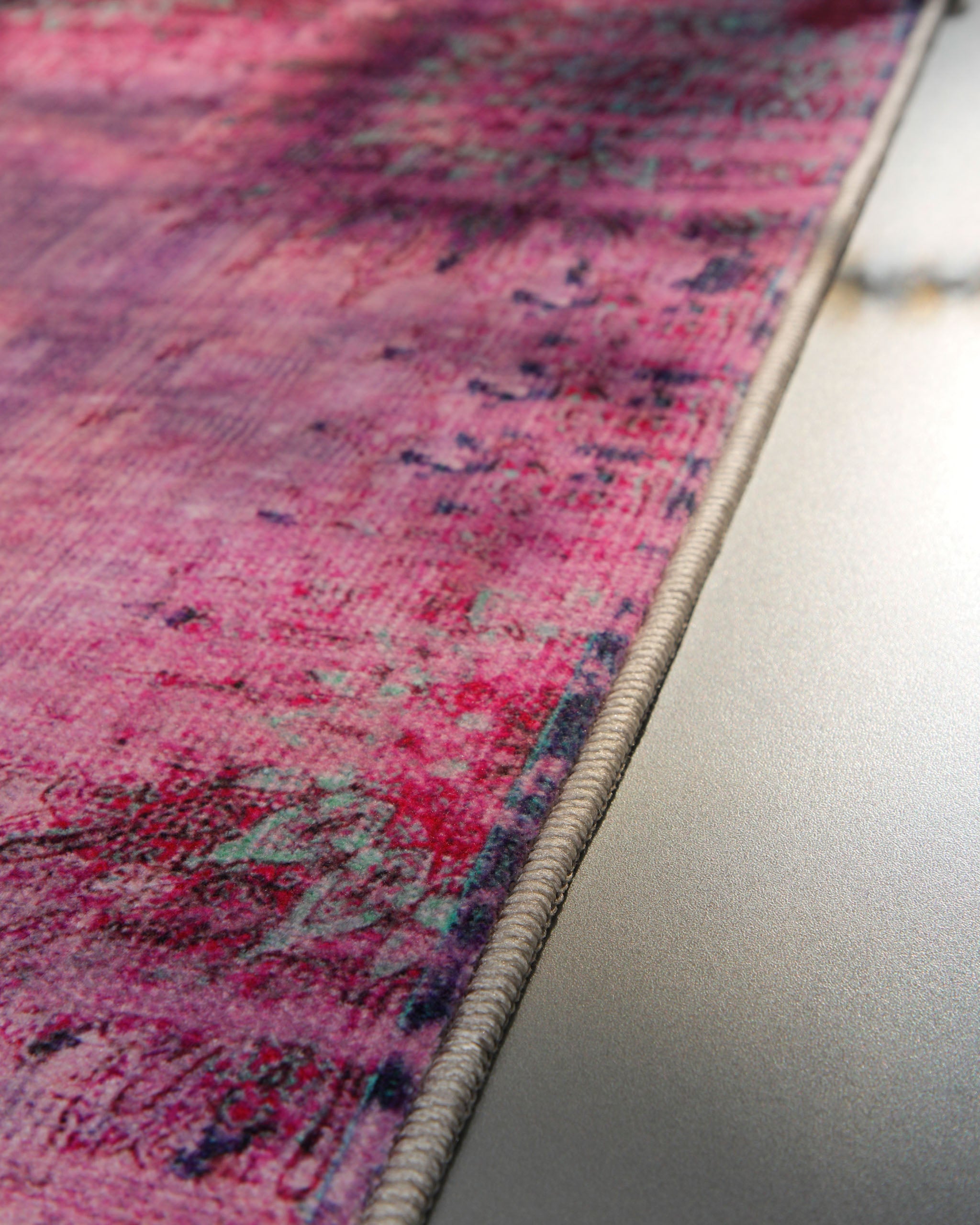 Nahaufnahme der sauber eingefassten Kante des Vintage-Badteppichs Healing in Violett-Multi.