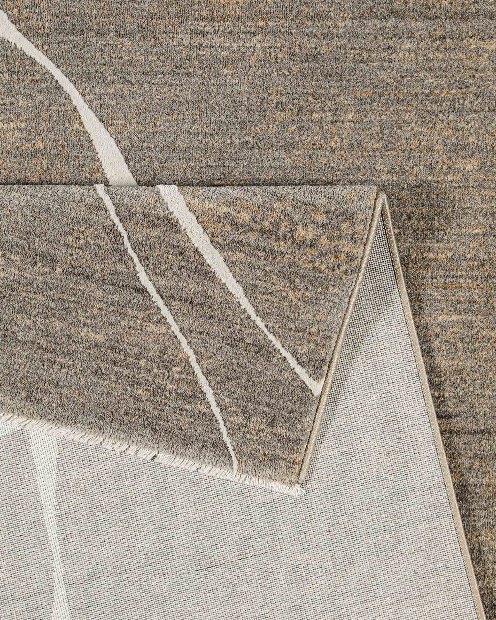 Esprit Kurzflor Teppich Elite in Beige Grau Detailaufnahme der Teppichkante und Verarbeitung