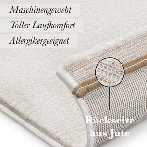 {"class" => "product-thumbnails__image", "alt" => "Kurzflor Teppich Freja Creme Weiß Detail der Rückseite mit sichtbarer Jute-Beschichtung"}