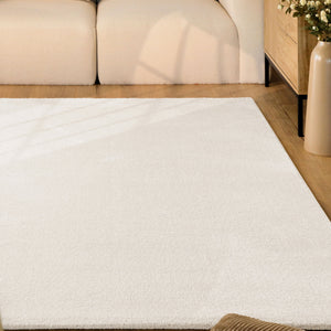 {"class" => "product-thumbnails__image", "alt" => "Kurzflor Teppich Vegas Creme im Wohnzimmer vor Sofa auf Holzboden, gleichmäßige helle Oberfläche sichtbar"}
